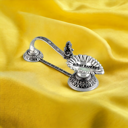 Buy Divine Silver Aarti Diya With Ganesh Murti Nikuressence AartiDiyaOnline GaneshAarti GaneshIdol GaneshMurti GaneshPuja HandcraftedSilver HinduDevotionalItems HinduPujaItems HinduPujaUtensils HinduRituals NikurEssenceSilver PujaCeremonyItems PujaEssentials PujaRoomDecor SilverAartiDiya SilverAartiDiyaSet SilverDecorItems SilverDiyaForPuja SilverGaneshMurti SilverHinduDiya SilverHomeDecor SilverIdol SilverIdols SilverPujaDiya SilverPujaItems